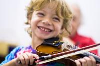 Photo of young boy playing the violin