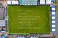 Poetry painted onto Barrow AFC's football pitch