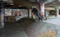 cyclist at a skate park covered in graffiti