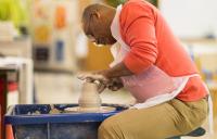 Photo of a man on a pottery wheel