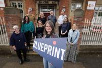 Image showing the Blueprint team with a banner