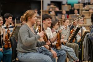 Young people playing classical music instruments