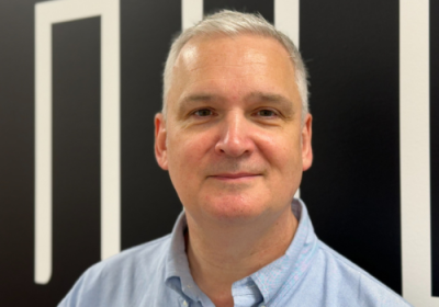 Mark Langley stands in front of a black and white background