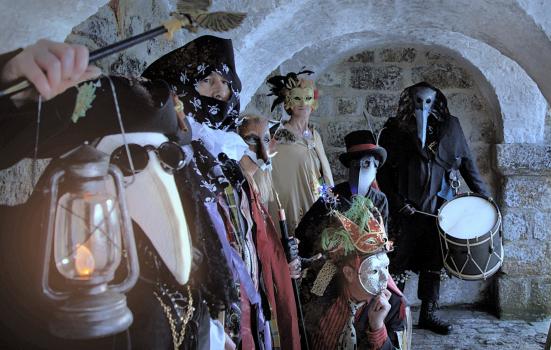 Photo of people dressed in costume in a vaulted room