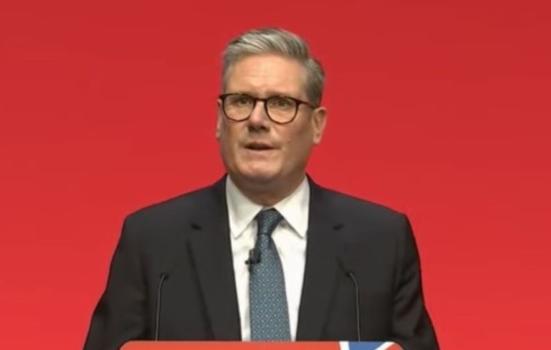 Kier Starmer speaks at a podium at the Labour Party confrence