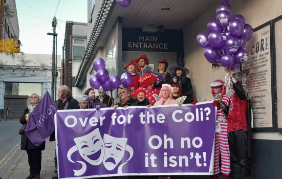 Save Oldham Coliseum campaigners outside the theatre holding banners and balloons