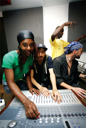 A group of group people use a mixing deck