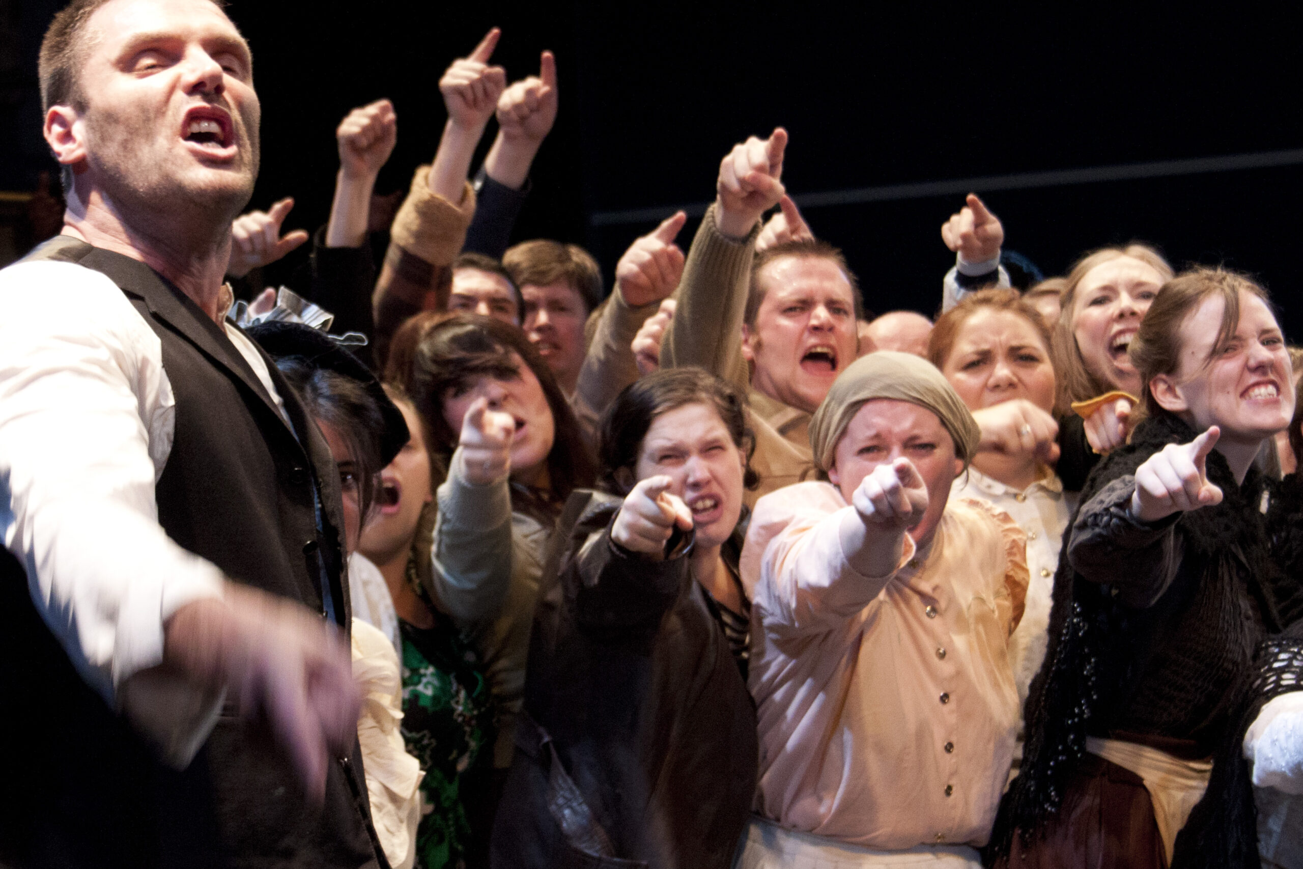 Photo of a production featuring a jeering crowd