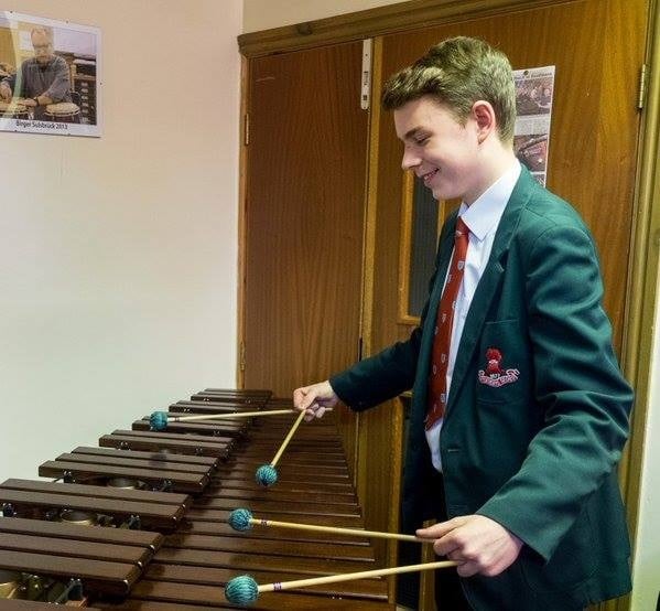 Photo of  boiy paying marimba