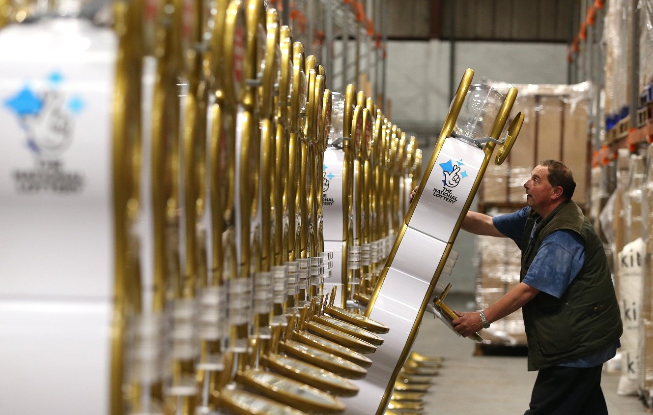 Photo of man moving a gold playstation in warehouse