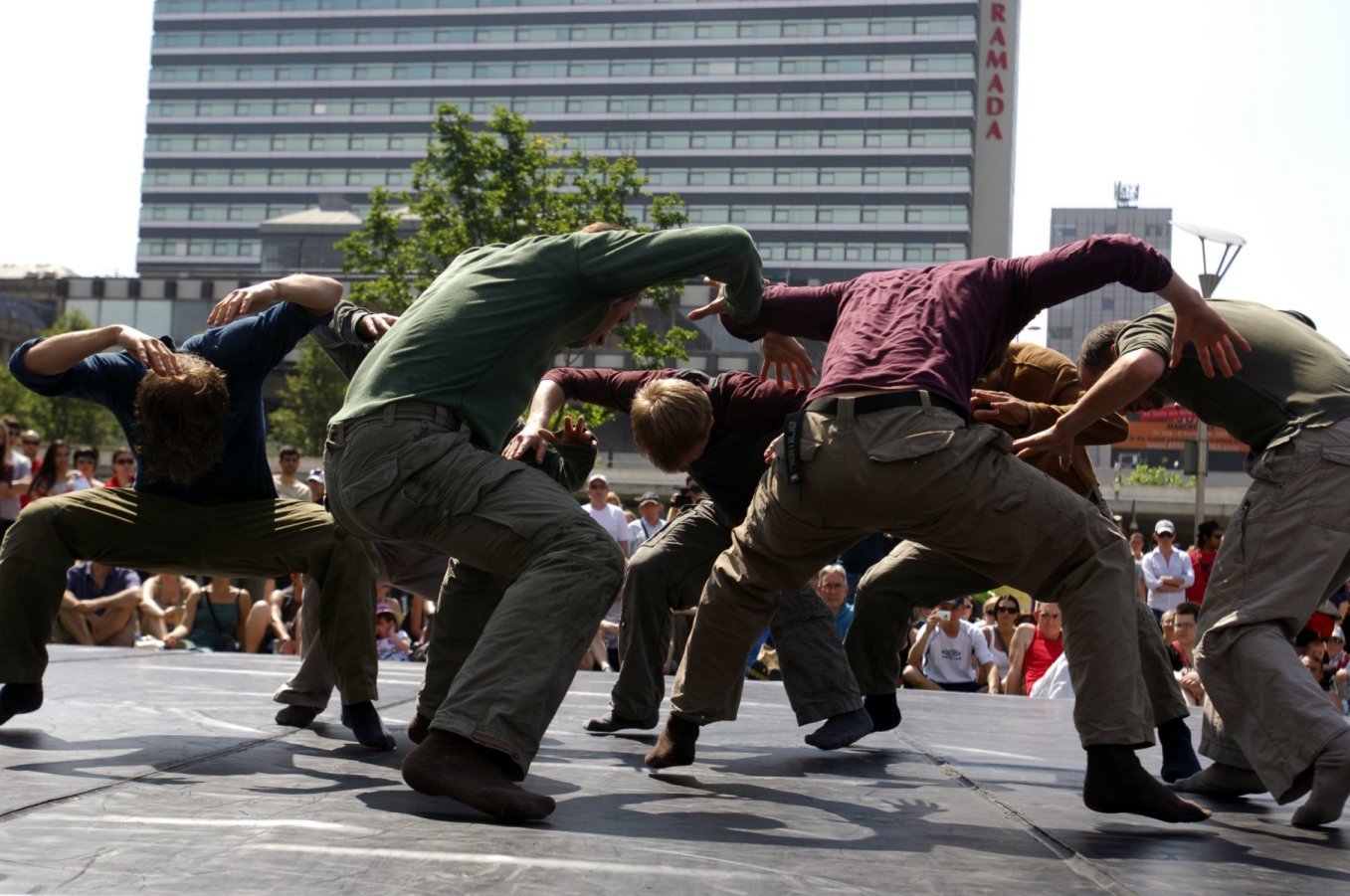 Photo of men dancing in city square