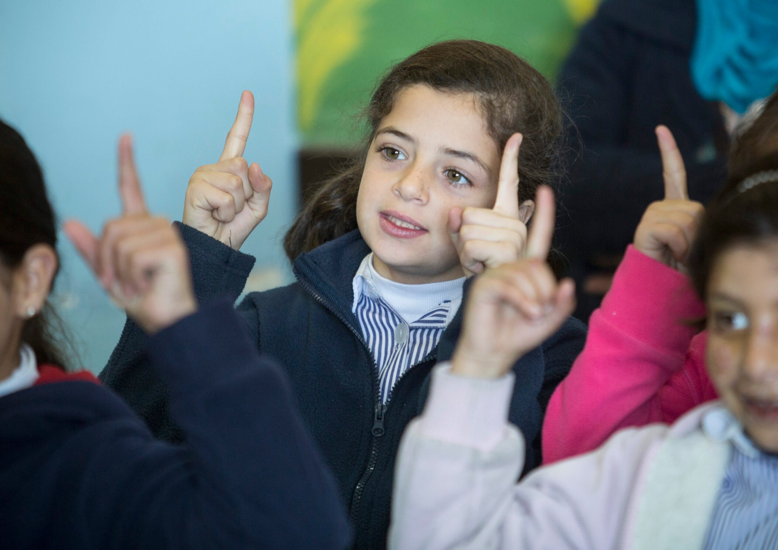 British Council World Voice Project Palestine, a group of girls pointing up