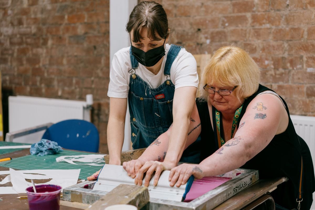 Two people doing silkscreening