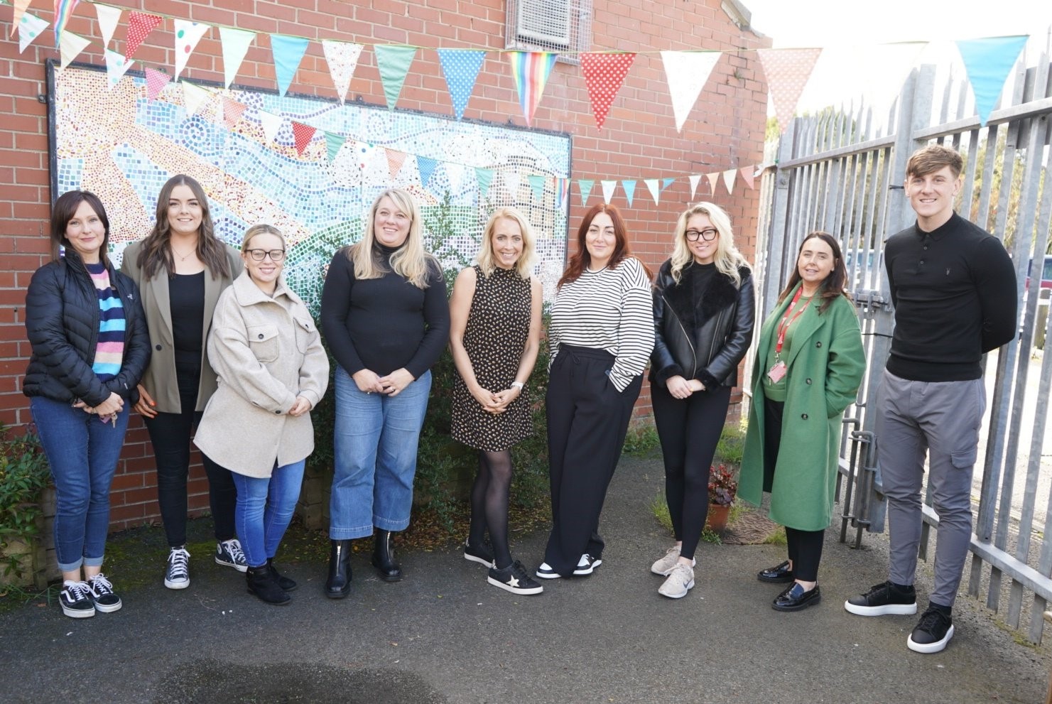 Programme Director Katy Shaw (centre) with Aine Brady and members of the Market Development Association and the wider Market community in Belfast