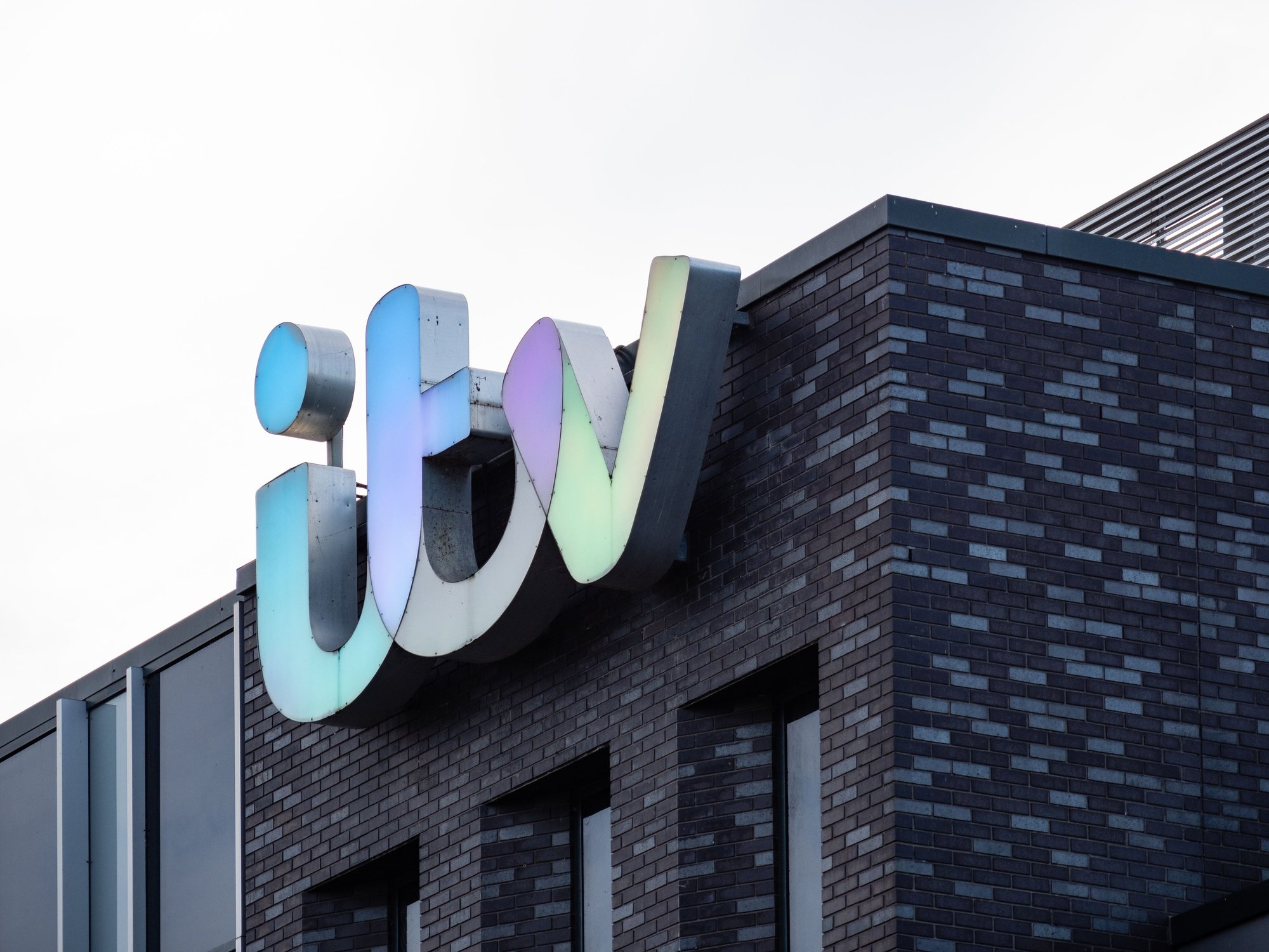 The ITV sign on the outside of the television station building in Manchester, UK