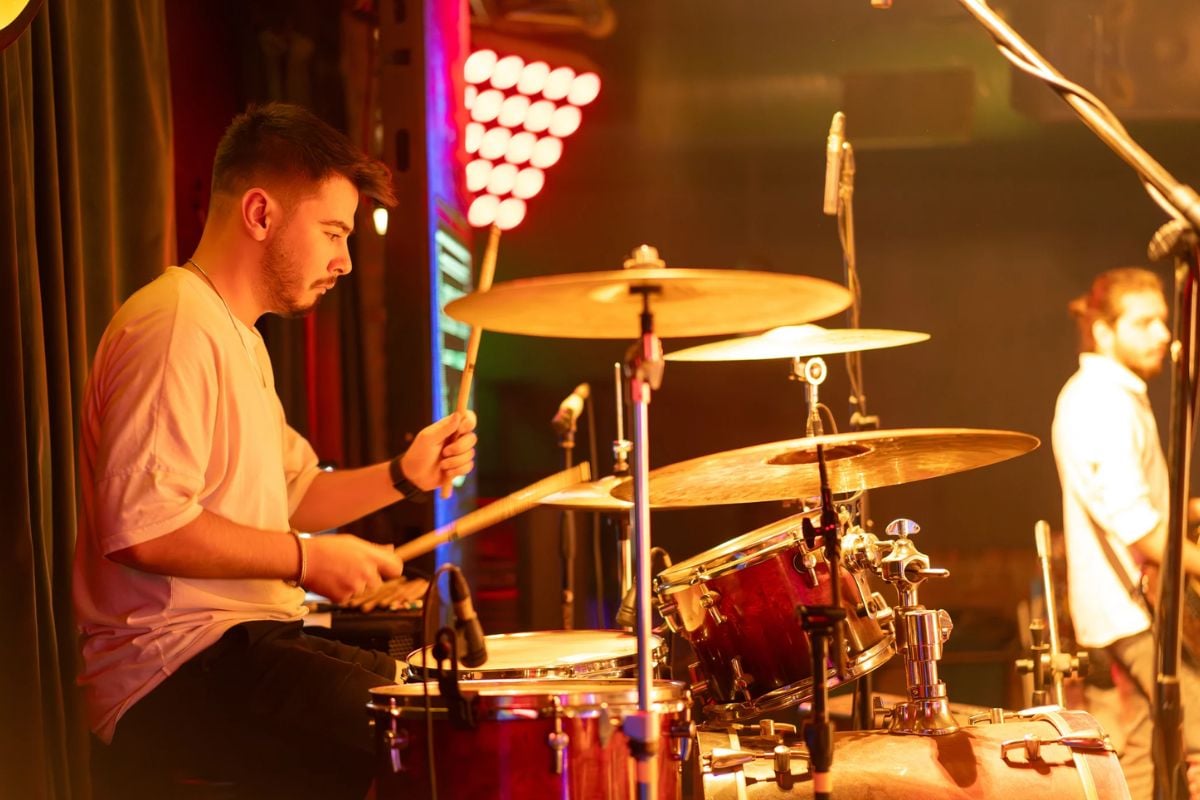 Musician plays drum on stage