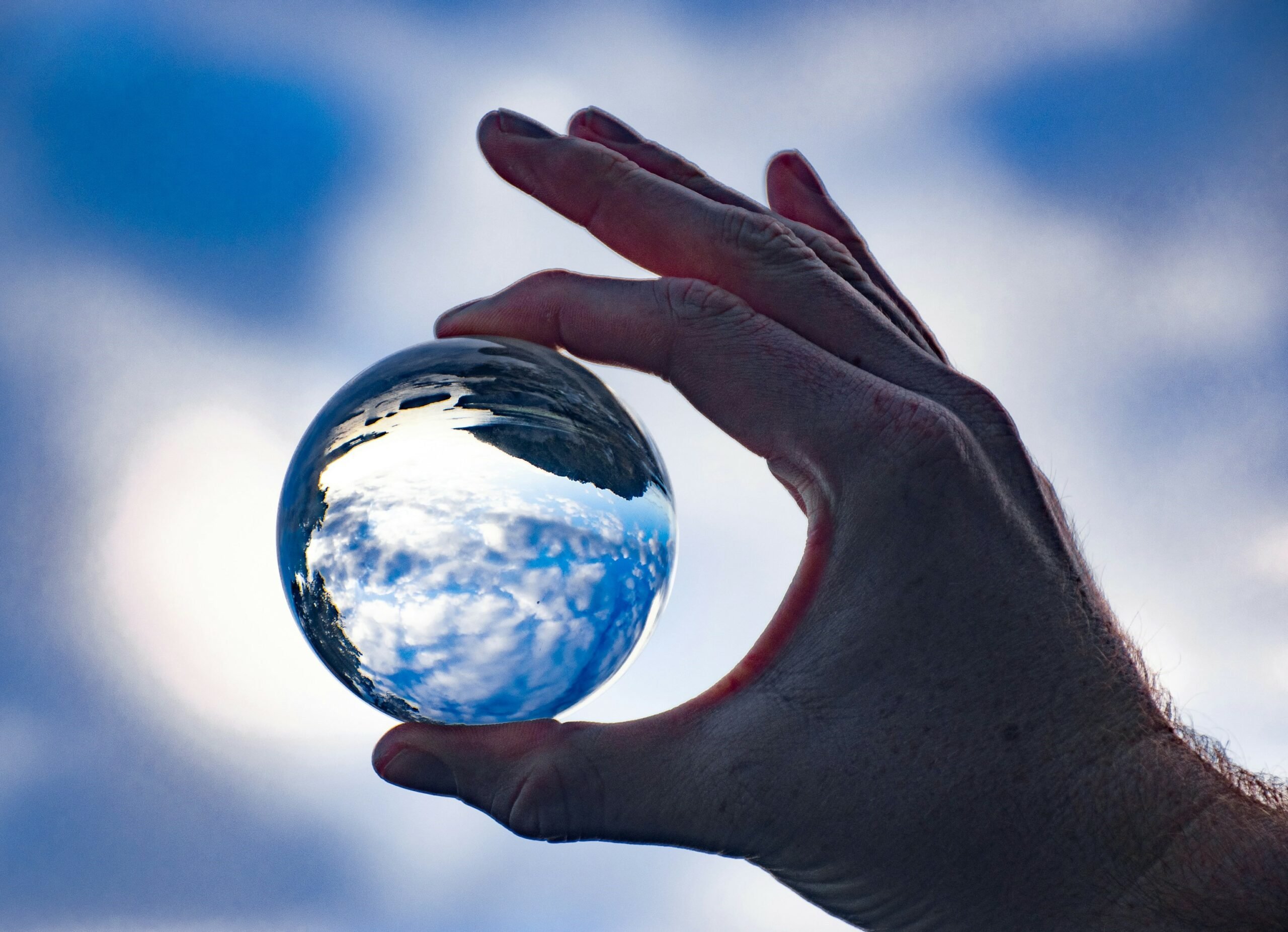 Hand holding a glass ball